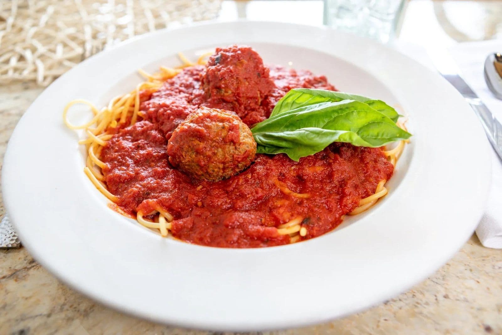 Spaghetti and meatballs with fresh basil